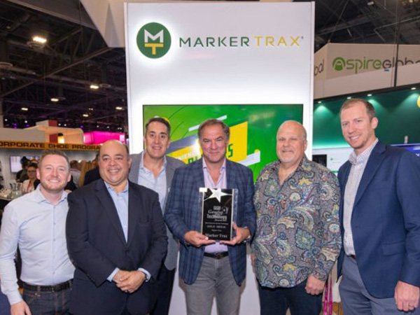 Photo of Marker Trax and Euronet employees holding an award from the gaming industry