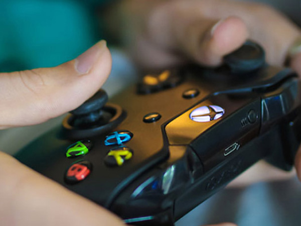 A photo of hands on an xbox gaming controller