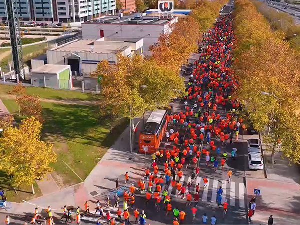 An aerial photo of joggers in a road race sponsored by Ria Money Transfer