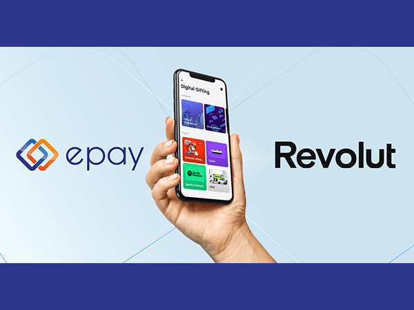 An image of a hand holding a smartphone with the Revolut app on it