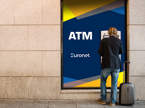 A photo of a man using a Euronet ATM