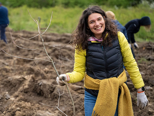 A photo of a Euronet Poland team member at the Time for the Forest tree planting