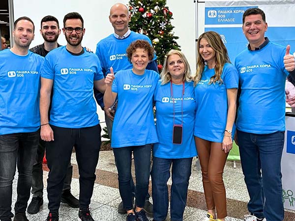 Employees of Euronet Greece serve at a Christmas Bazaar in 2023.